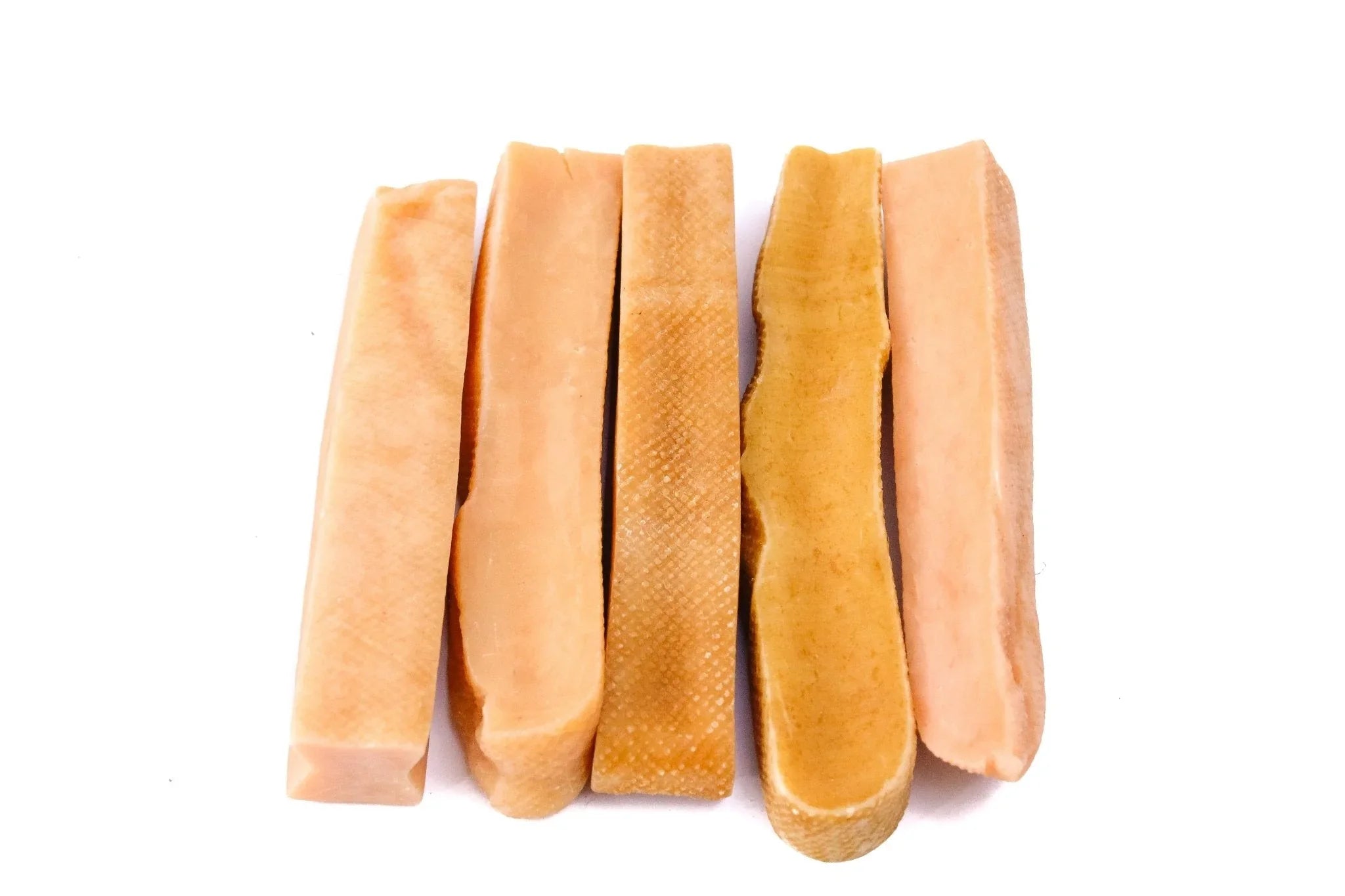 Large yak snak dog chew sticks arranged on white background