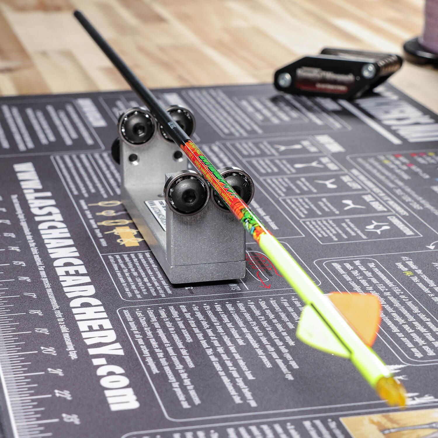 Archery squaring tool with arrow on mat, arrow squaring device for bow tuning