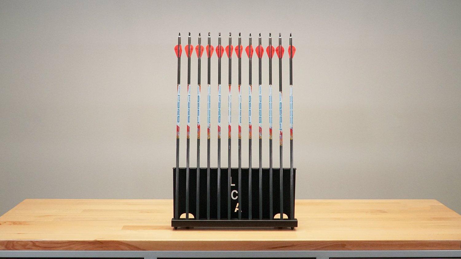 Last Chance Archery arrow stand holding multiple arrows on a wooden table