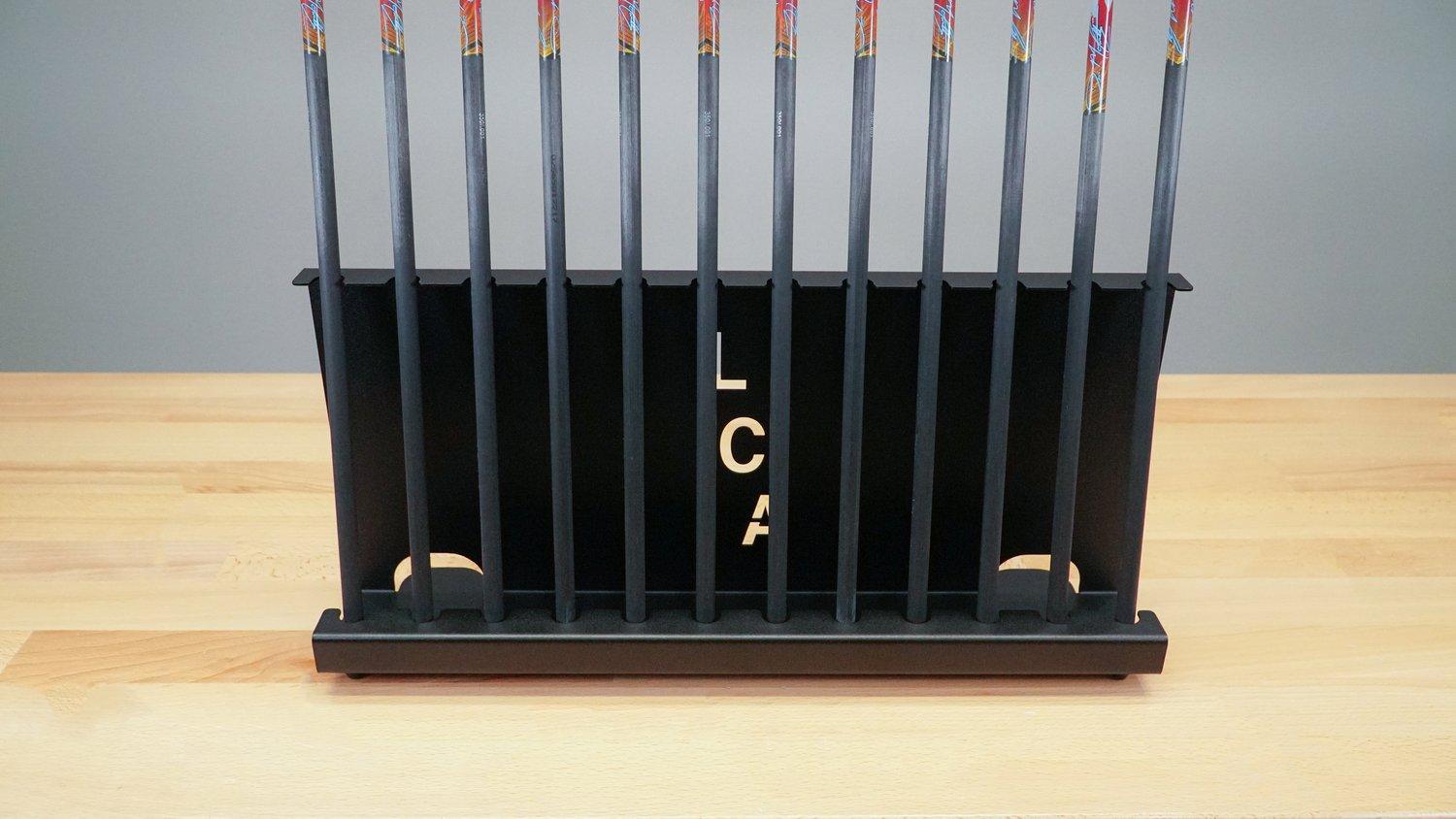 Last Chance Archery arrow stand holding arrows on a light wood table