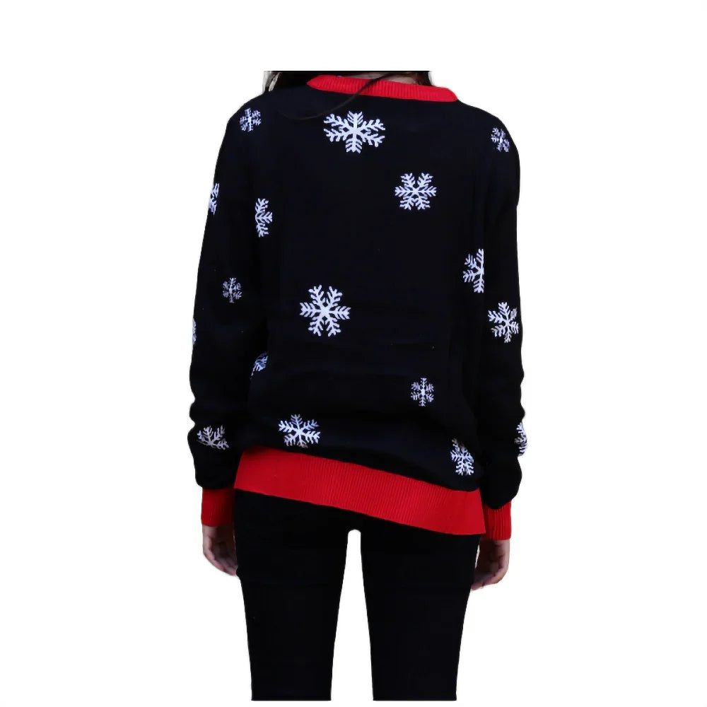 Woman in black sweater with white snowflake pattern and red trim, back view