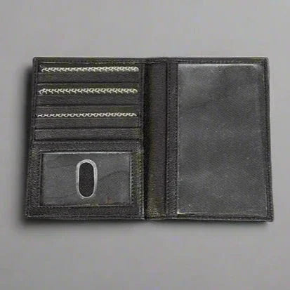 Black leather wallet open with card slots and ID window on gray background