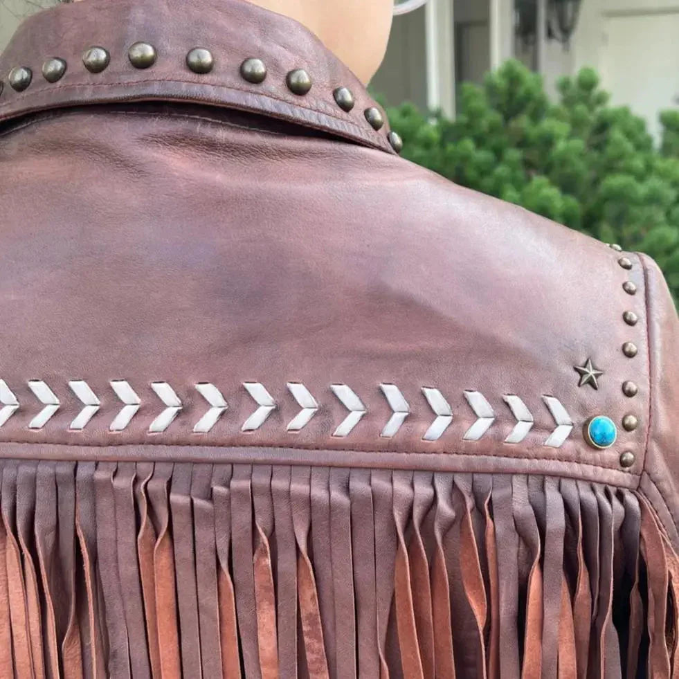 Brown leather western jacket with fringe, studded details, chevron pattern, and turquoise accent