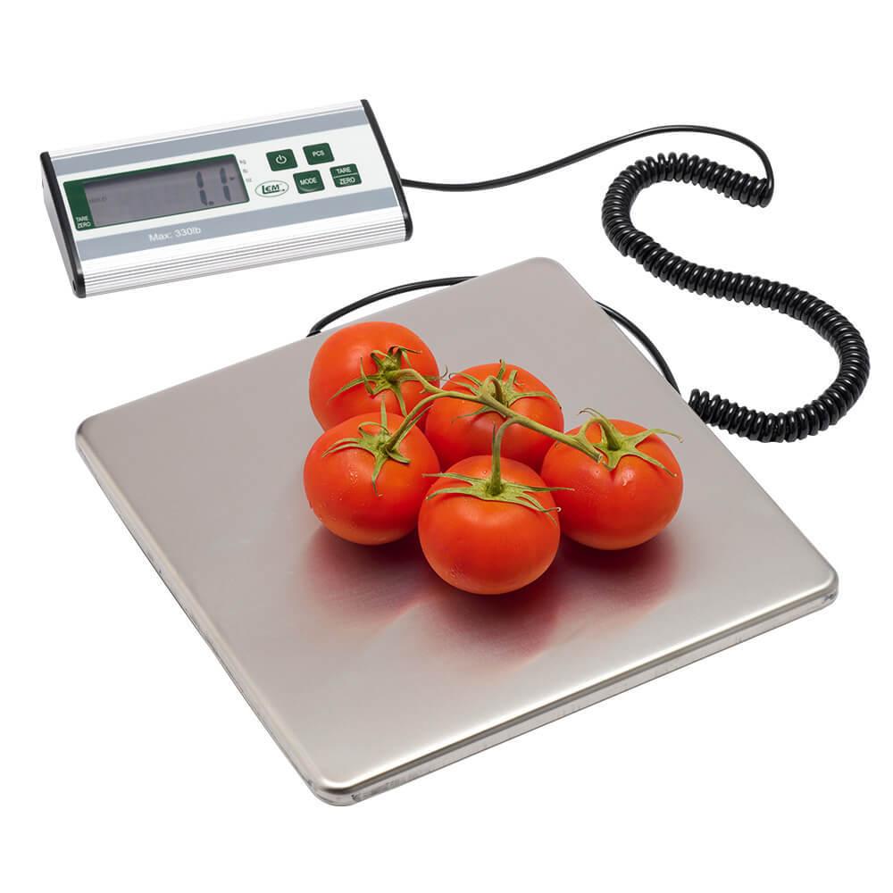Cluster of fresh tomatoes on digital kitchen scale with display