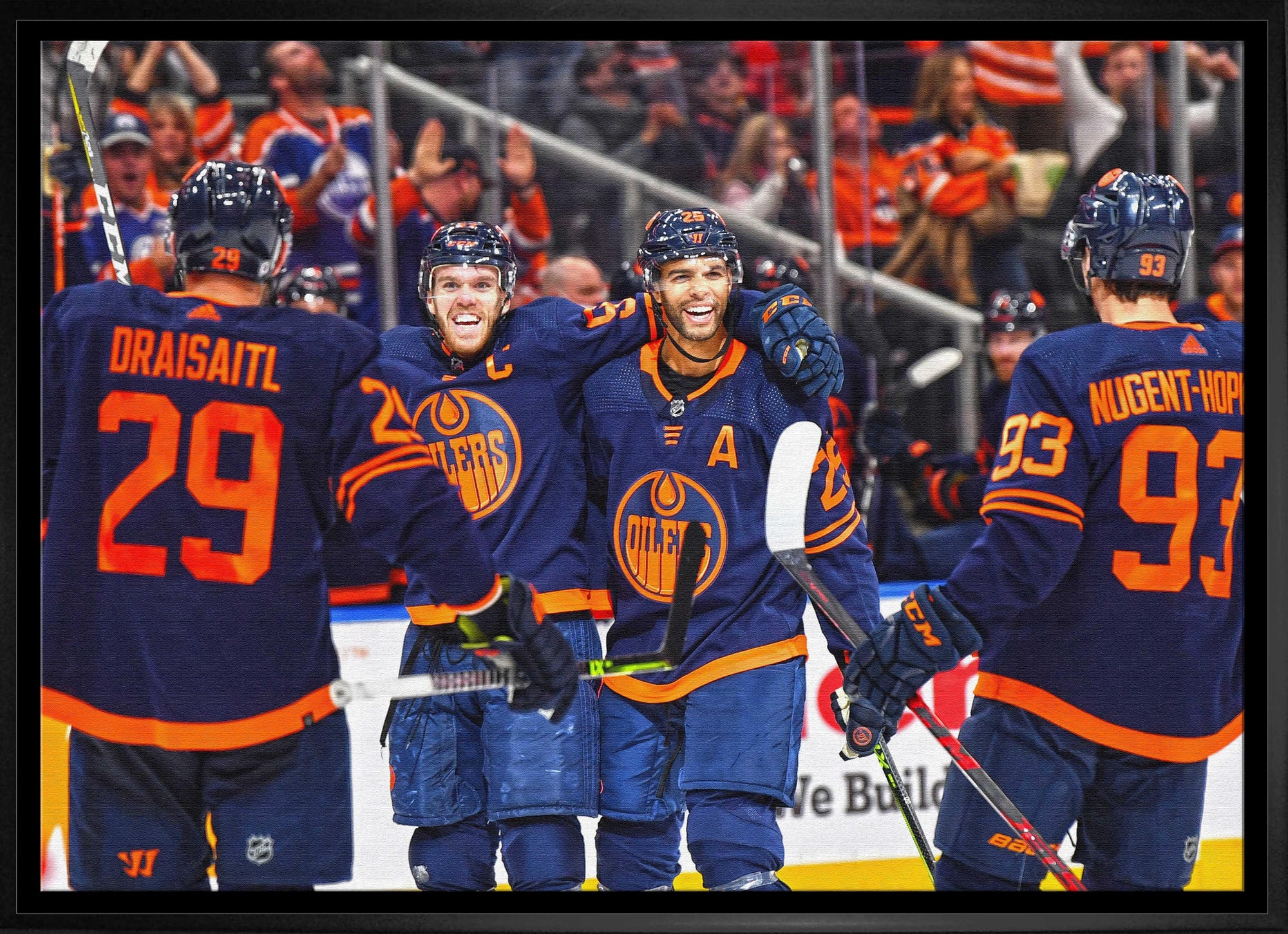 Edmonton Oilers hockey players celebrating on ice in blue jerseys.