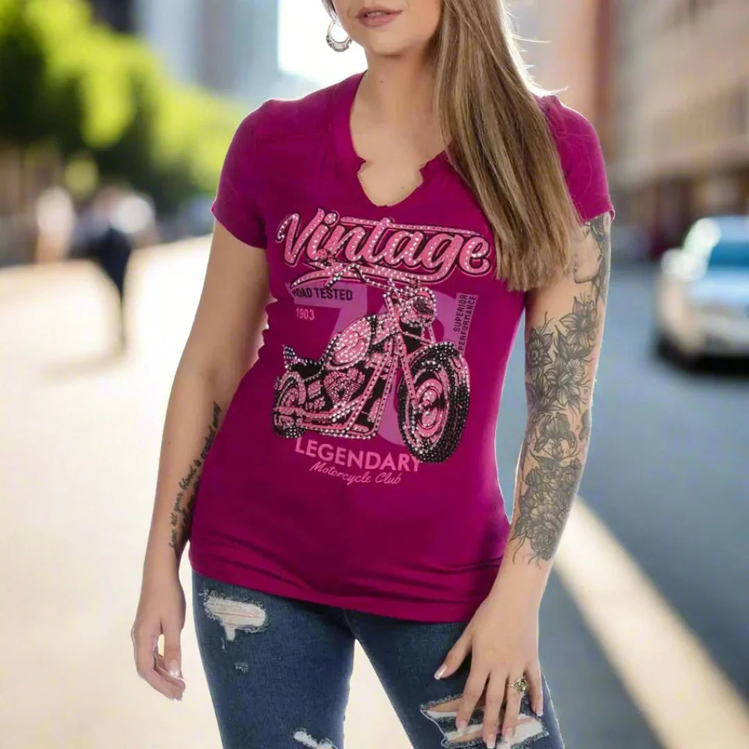 Woman wearing magenta Liberty Wear Spitfire vintage motorcycle t-shirt on city street
