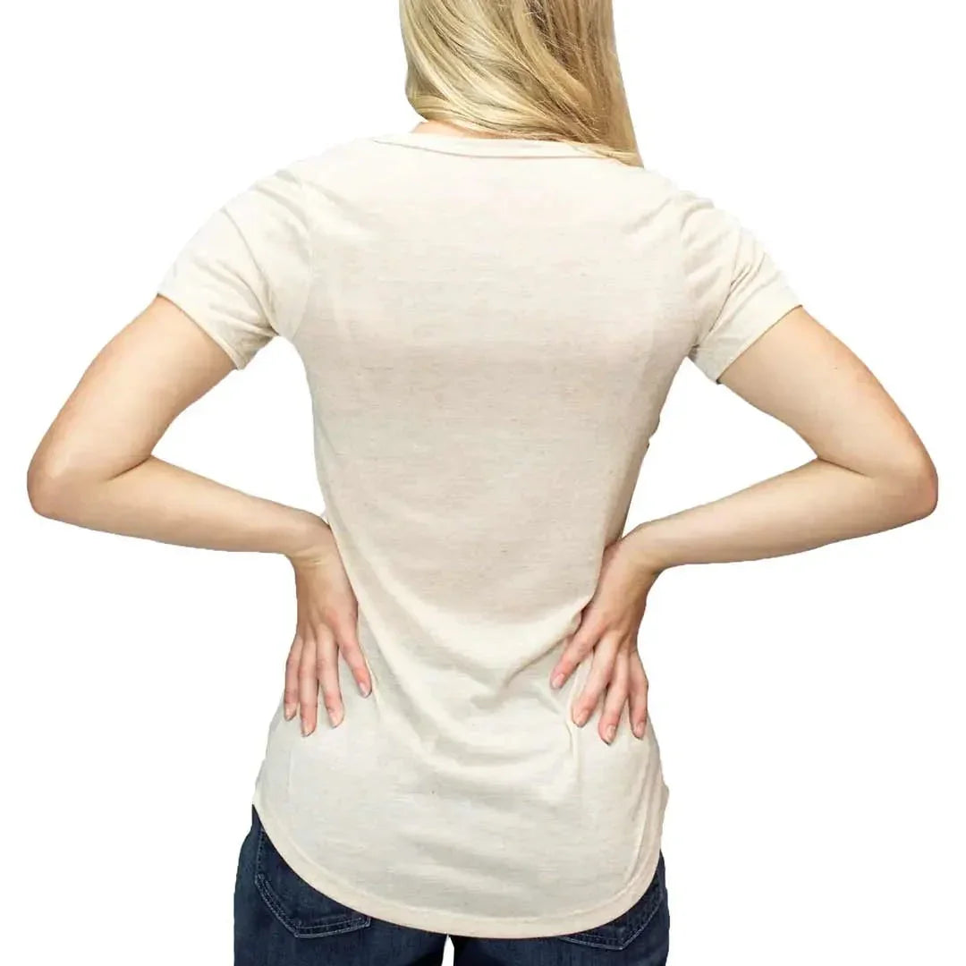 Back view of woman in plain beige short-sleeve t-shirt and jeans on white background