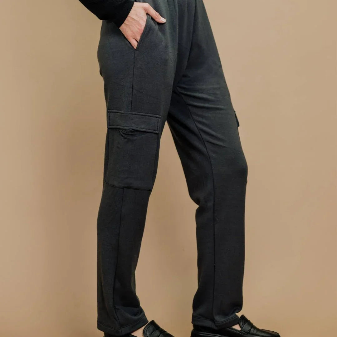 Black bamboo fleece ladies cargo pants with pockets, styled with black shoes, side view