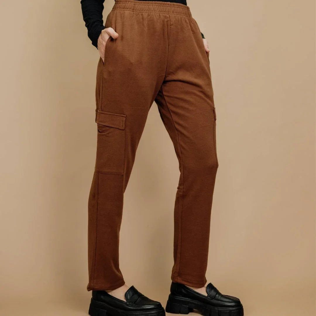 Brown bamboo fleece cargo pants for women, side pockets, modeled against beige background