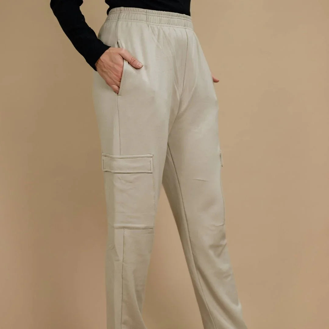 Beige bamboo fleece ladies cargo pants with pockets, modeled against a neutral background.