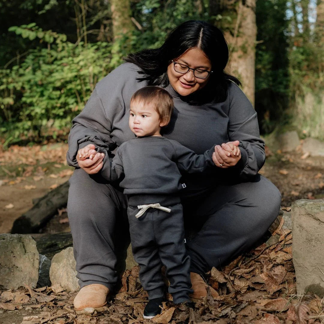 Woman and child in matching grey bamboo fleece cargo pants outdoors in the forest