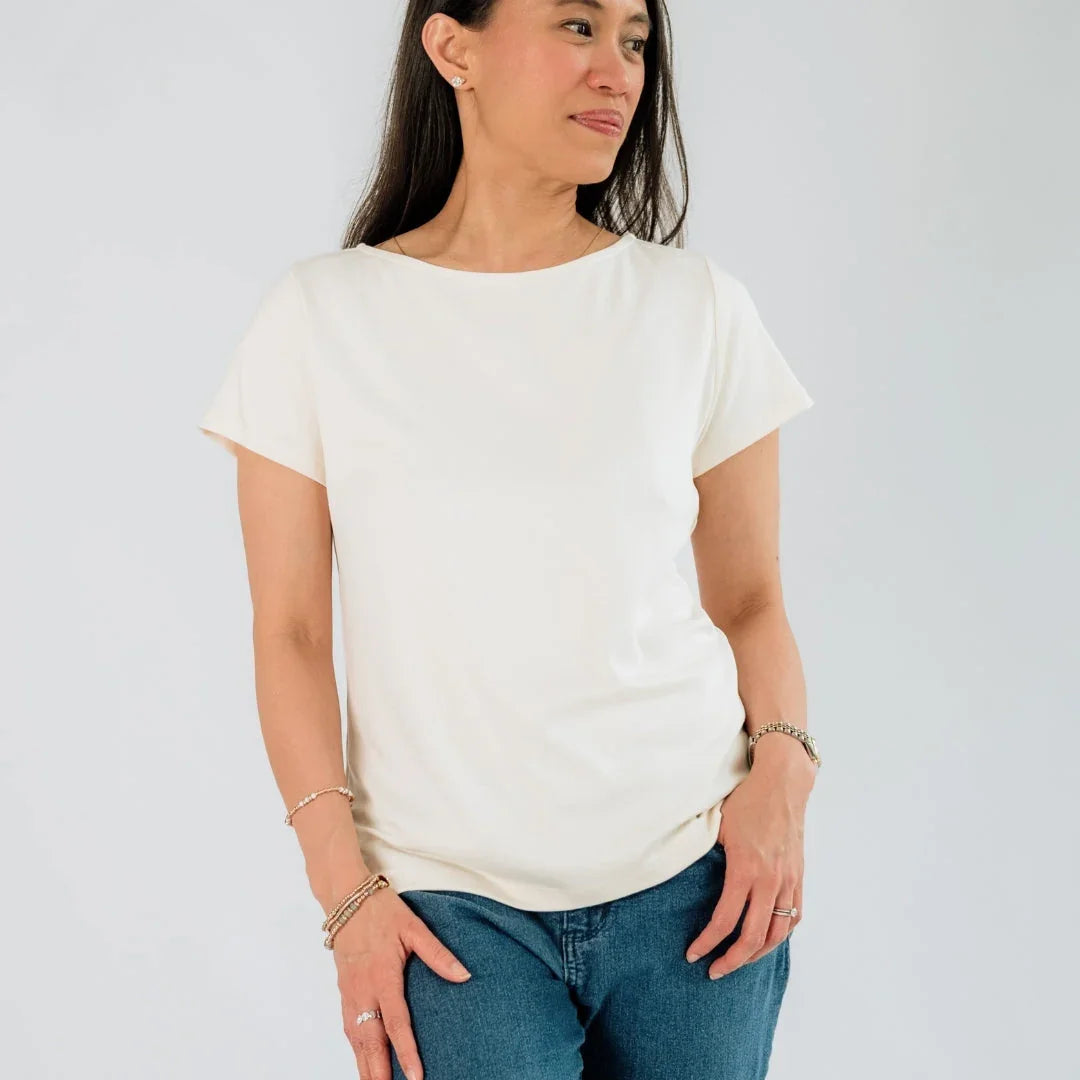 Woman wearing plain white short-sleeve t-shirt and blue jeans against white background