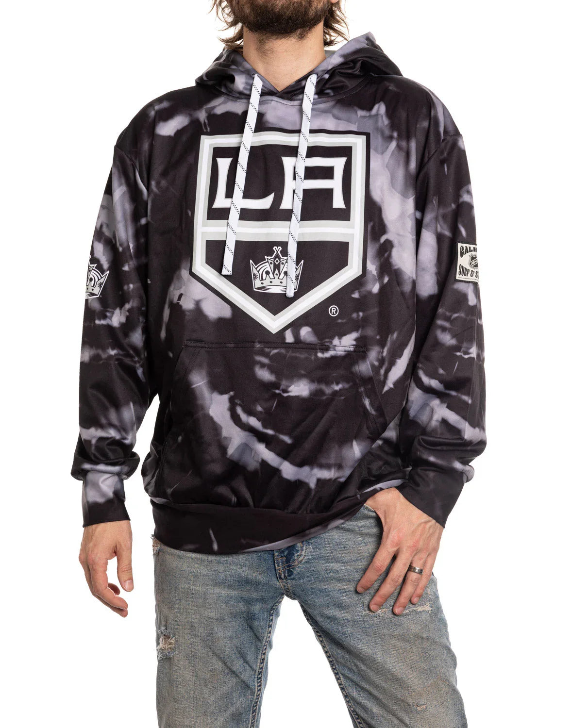 Man wearing black and gray LA Kings tie-dye sublimation hoodie and distressed jeans