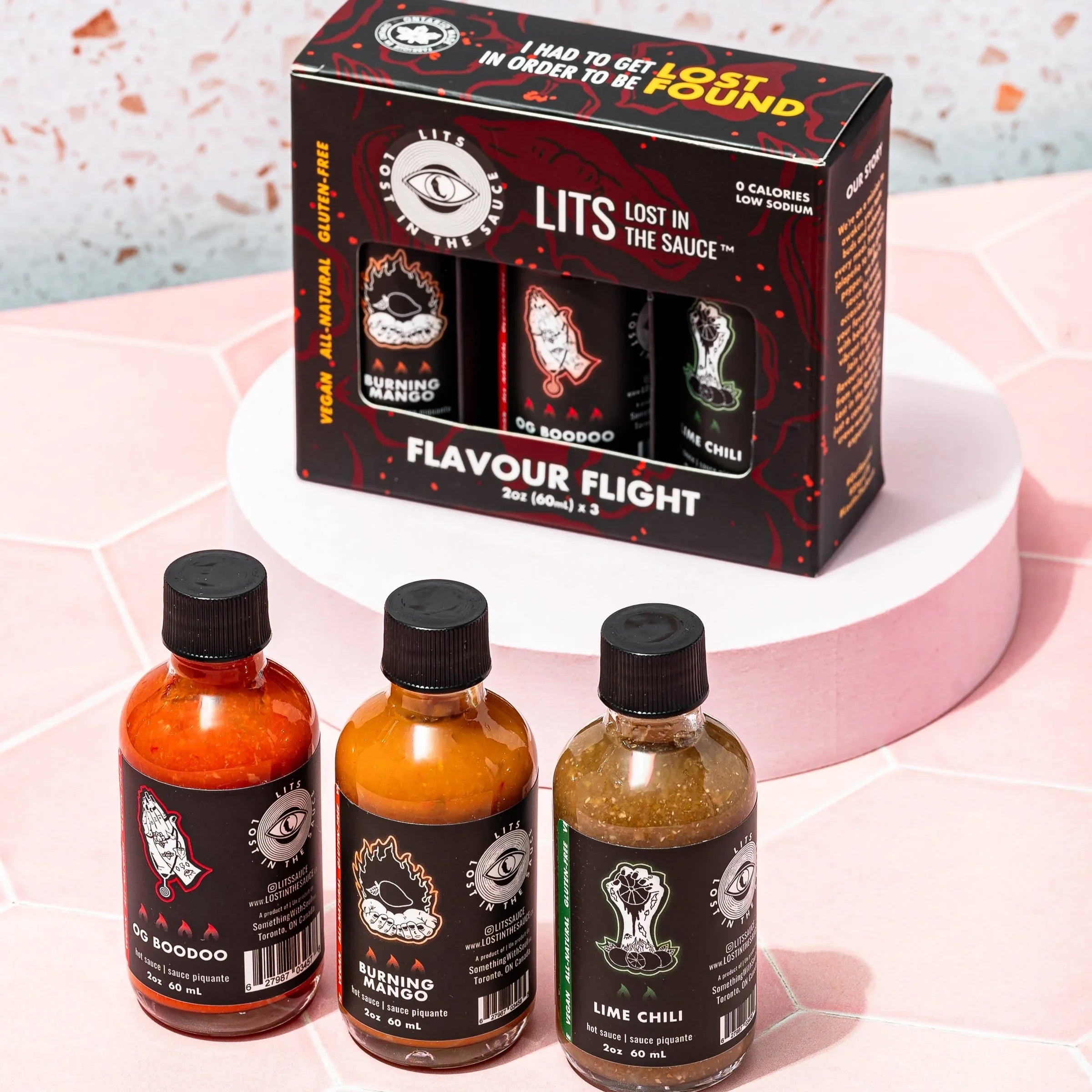 LITS Flavour Flight hot sauce gift set with three labeled bottles on a pink surface