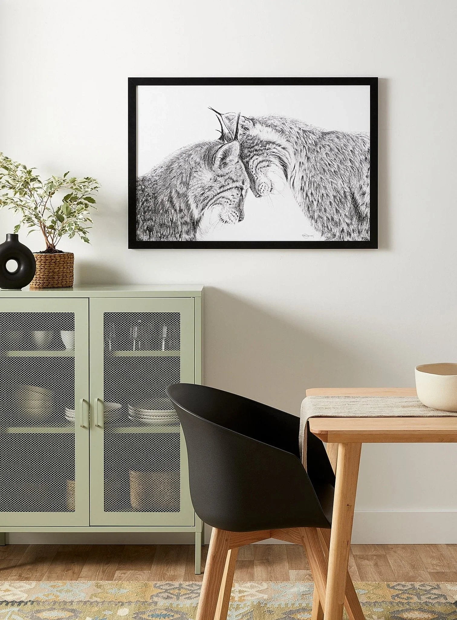 Lynx illustration wall art in modern living room with green cabinet and black chair