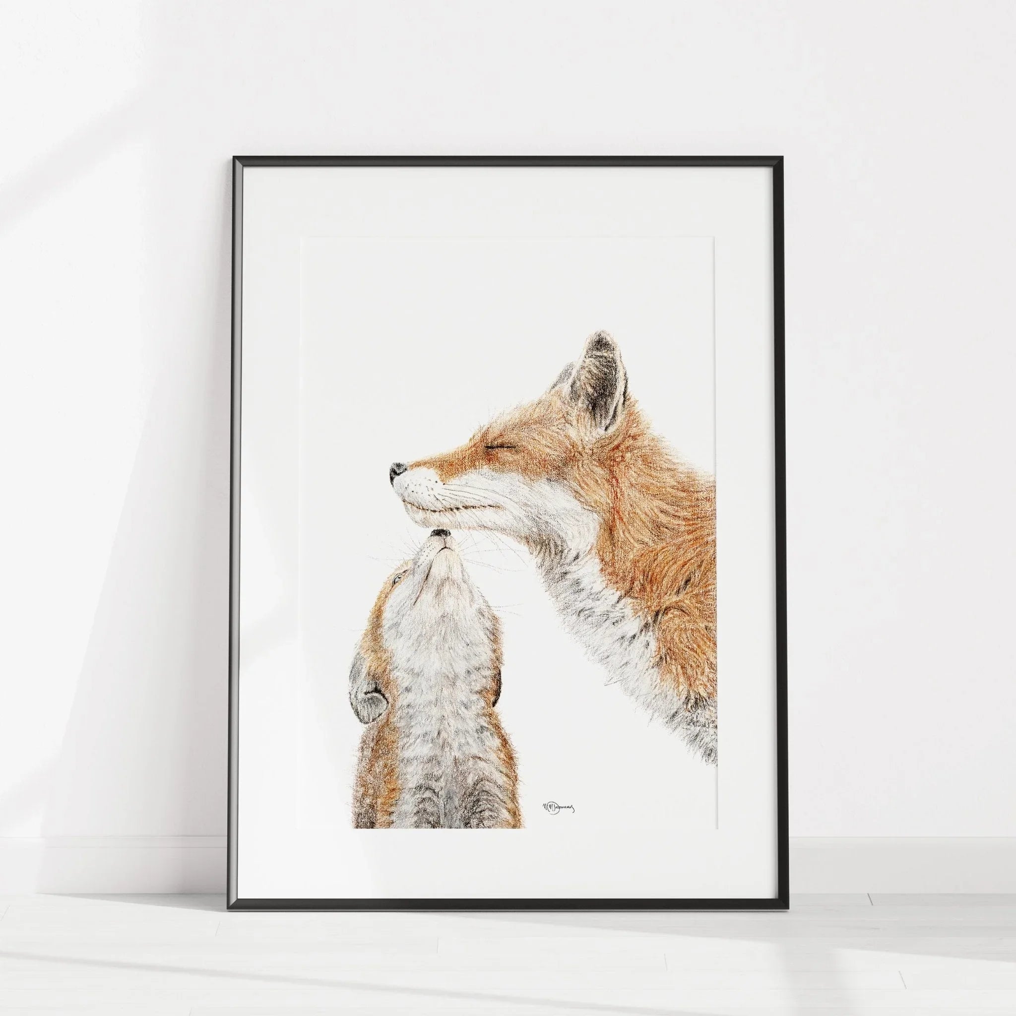 Framed art print of a mother fox nuzzling a baby fox, minimalist white background