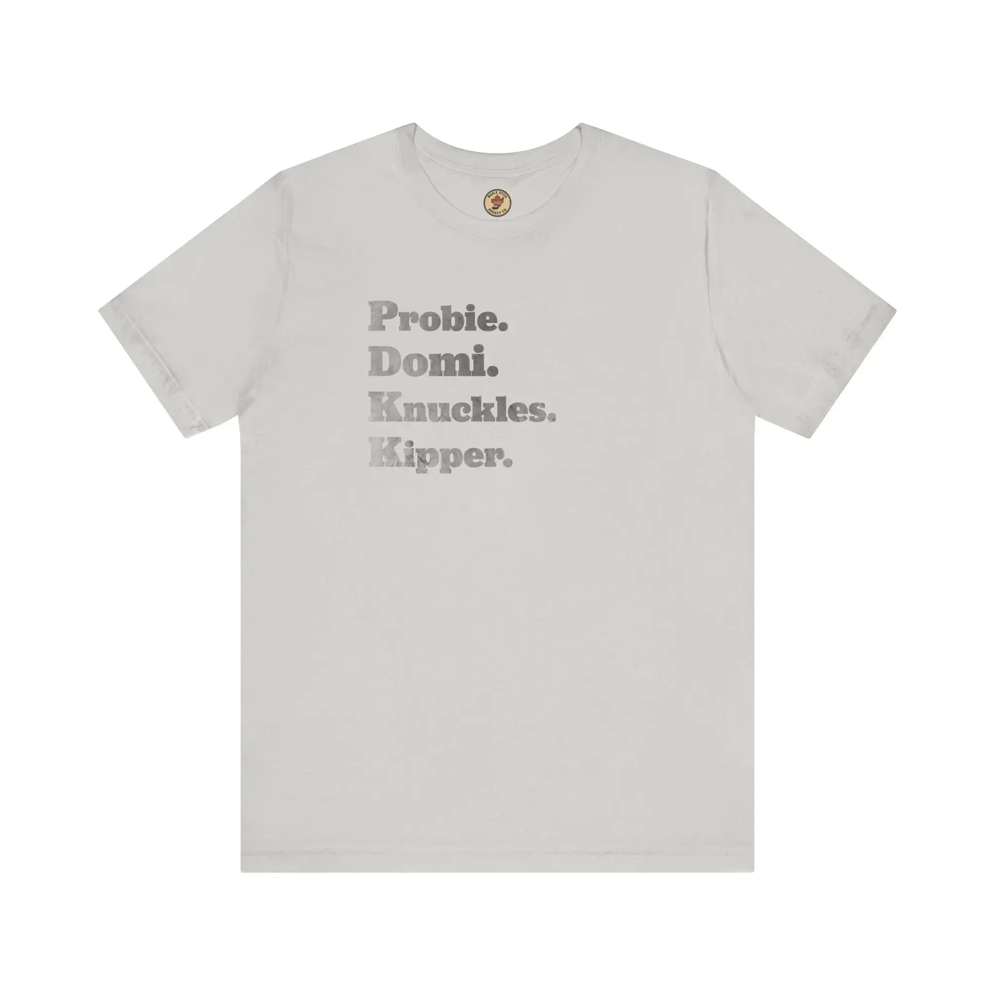 White t-shirt with gray text reading Probie. Domi. Knuckles. Kipper. on front, flat lay.