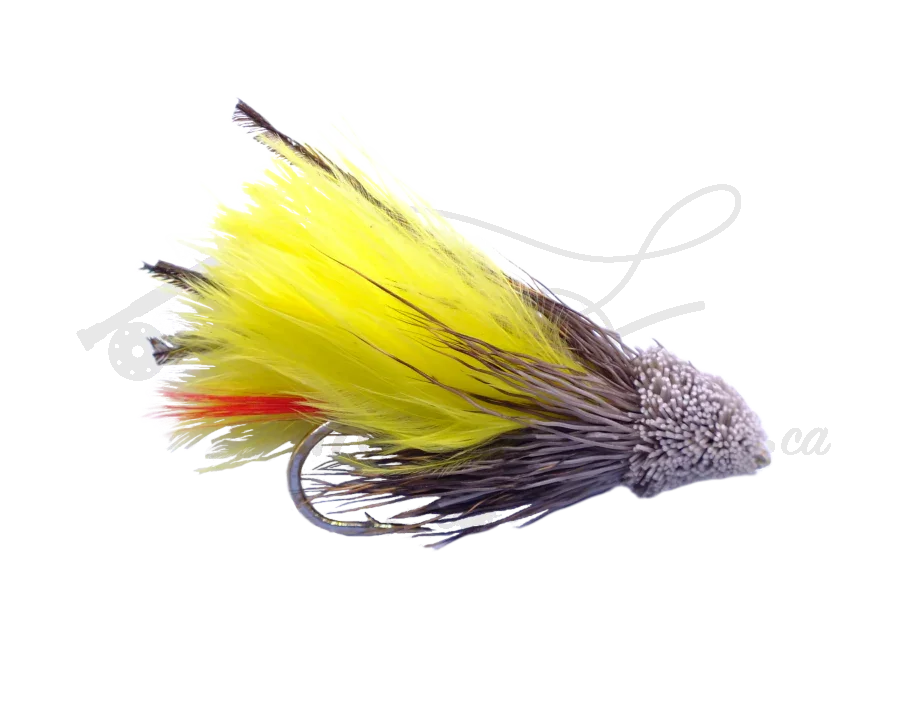 Yellow Marabou Muddler fly fishing lure with feather and deer hair body on white background