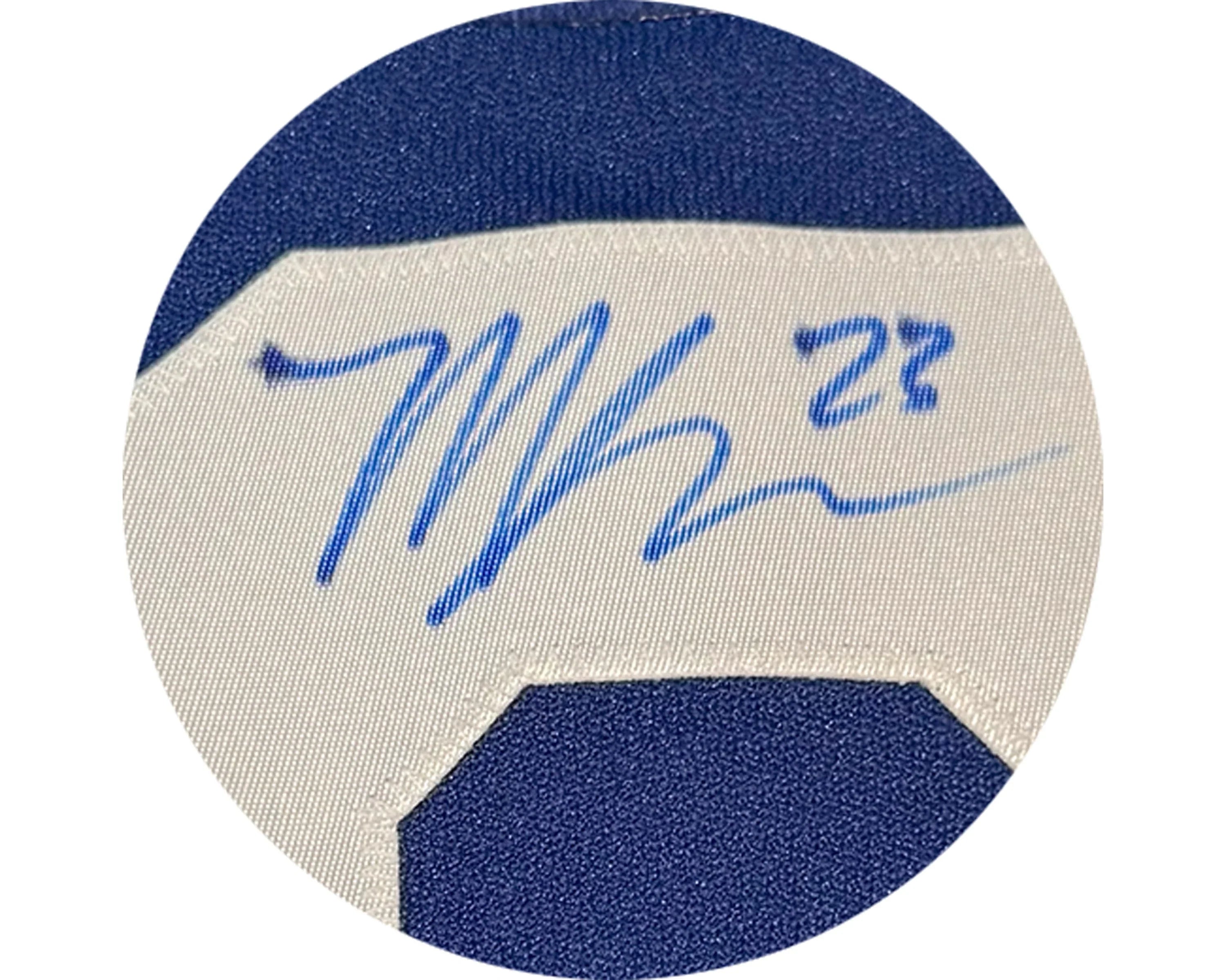 Blue marker signature and number 27 on white and blue sports jersey fabric close-up