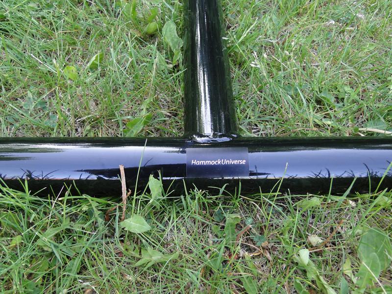 Hammock chair stand black metal base on grass, labeled Hammock Universe.