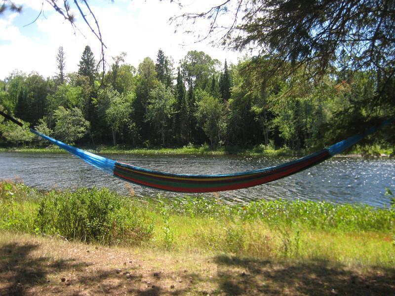 XL Mayan hammock with thick cord hanging by a riverbank in a forest setting