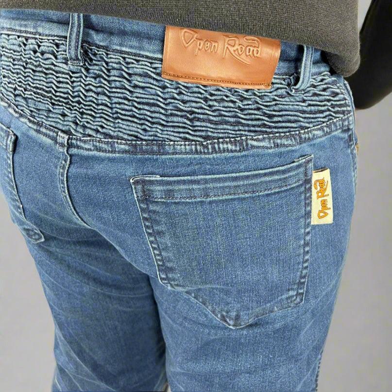 Close-up of Open Road blue jeans with elastic waist and leather patch label