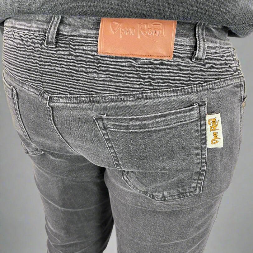 Close-up of Open Road gray jeans back, featuring logo patch and ribbed waist detail