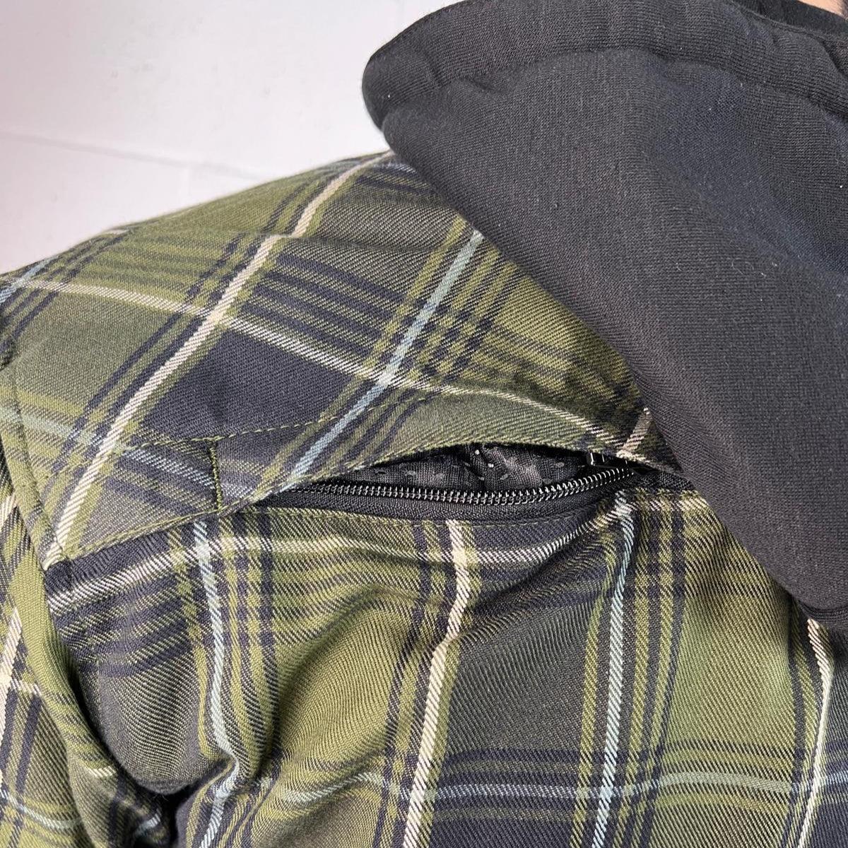 Green plaid jacket with black zipper detail and black hood in close up view