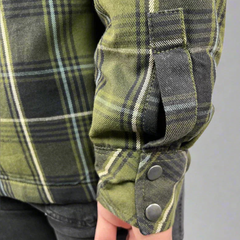 Close-up of green plaid flannel shirt sleeve with snap buttons