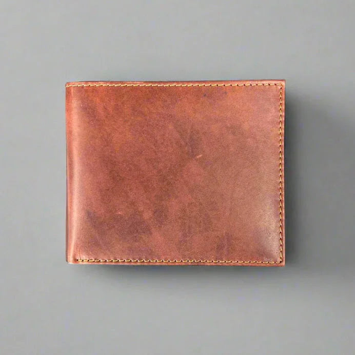 Brown leather wallet with visible stitching on a gray background