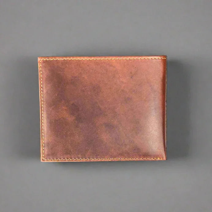 Brown leather wallet with visible stitching on grey background