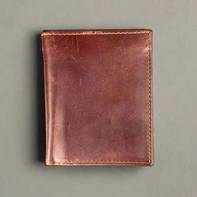 Brown leather wallet on a gray background, classic men's accessory