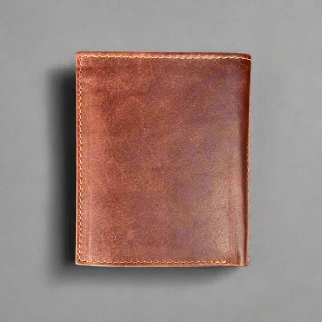 Brown leather wallet on gray background, minimalist handmade men's accessory