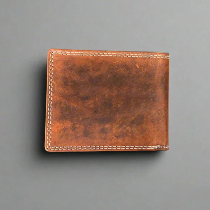 Brown leather wallet with visible stitching on gray background
