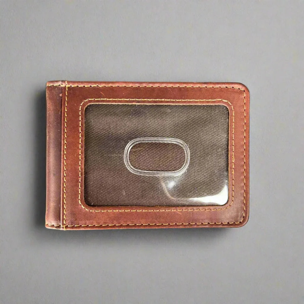 Brown leather wallet with ID window on gray background
