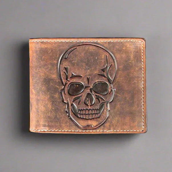 Brown leather wallet with embossed skull design, rustic style accessory on gray background