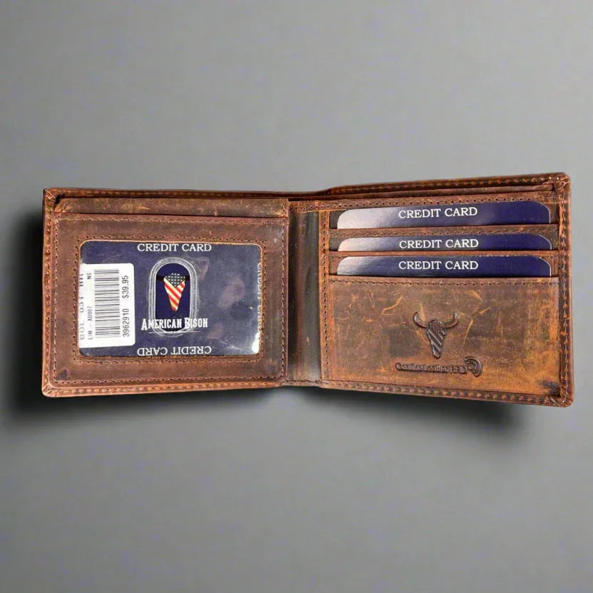 Open brown leather wallet with credit cards and American Bison logo on gray background