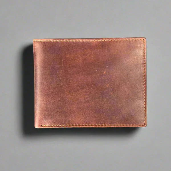 Brown leather wallet on a gray background, minimalist men's accessory