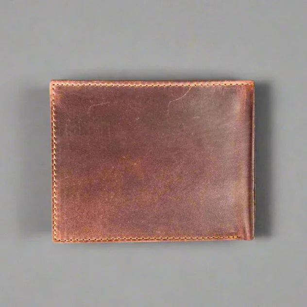 Brown leather wallet with visible stitching on a gray background