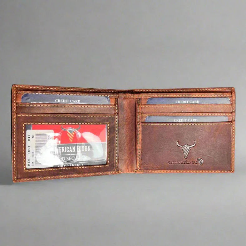Open brown leather wallet with visible credit cards and embossed bison logo on gray background