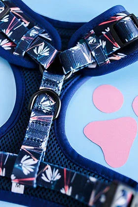 Navy blue floral dog harness with mesh fabric on blue background, pink paw print decor