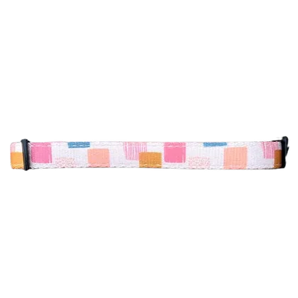 Adjustable pet collar with pink, orange, and blue square pattern on white background