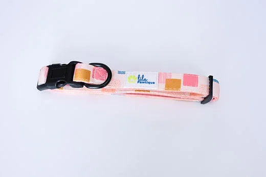 Pink and orange geometric dog collar with black buckle on white background