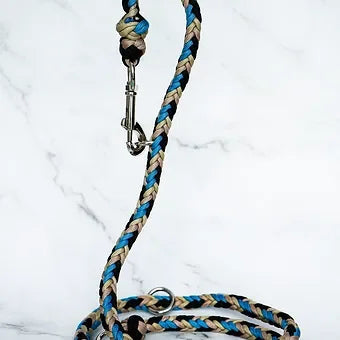 Blue, tan, and black braided dog leash with metal clasp on marble background