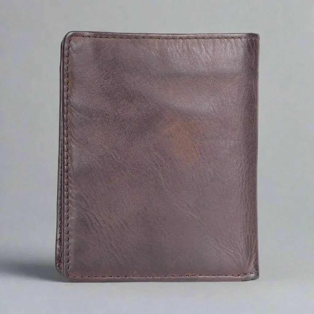 Brown upright men's leather wallet on a plain gray background