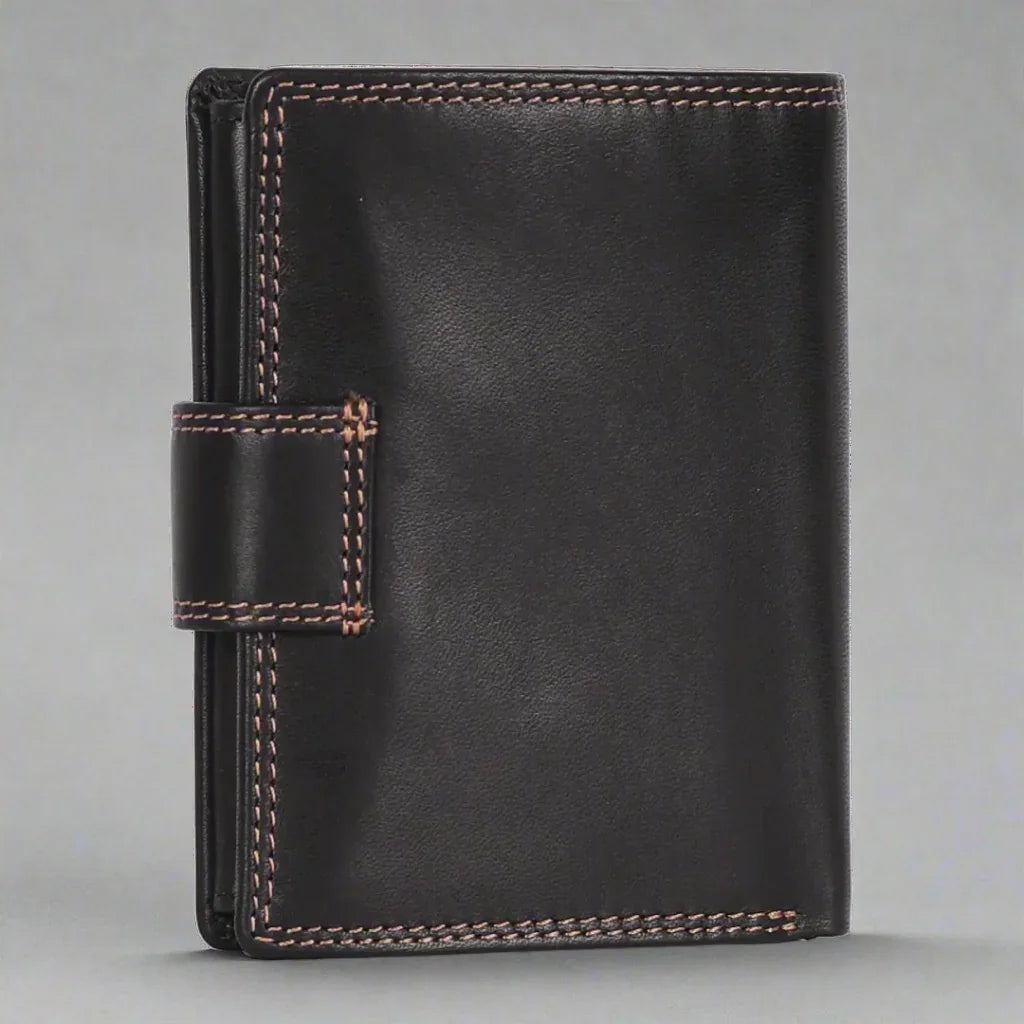 Black leather wallet with tan stitching and snap closure on grey background