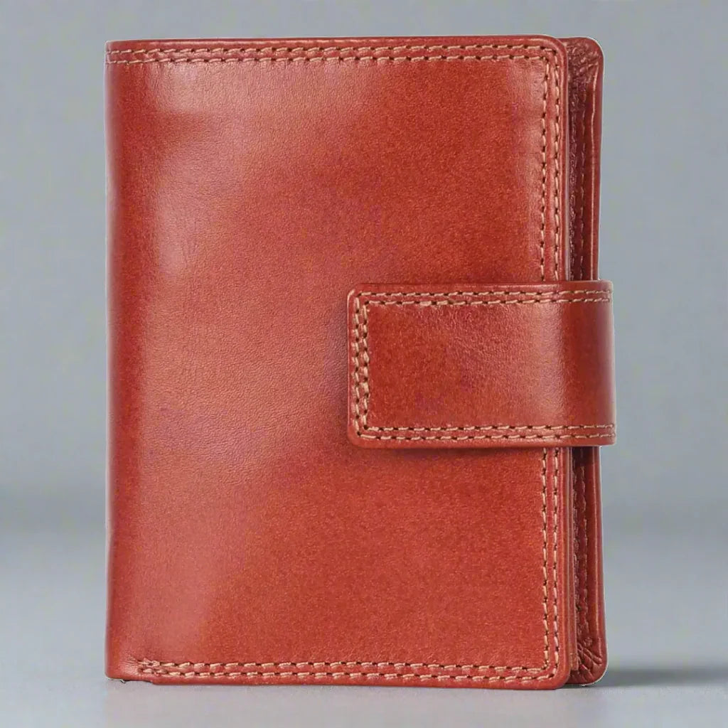 Cognac brown leather wallet with snap closure on gray background