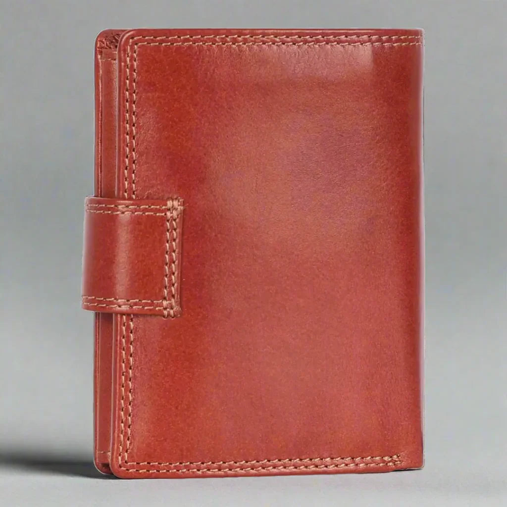 Cognac brown leather wallet with stitched edges and snap closure on a plain background