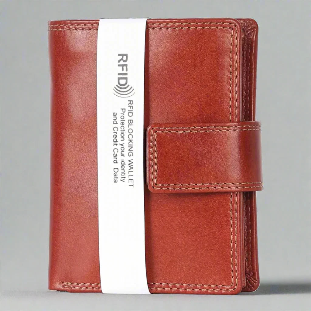 Cognac brown leather RFID blocking wallet with strap closure, front view on gray background