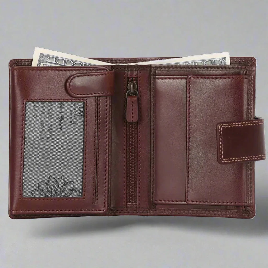 Open brown leather wallet with cash, zipper pocket, and ID window on gray background